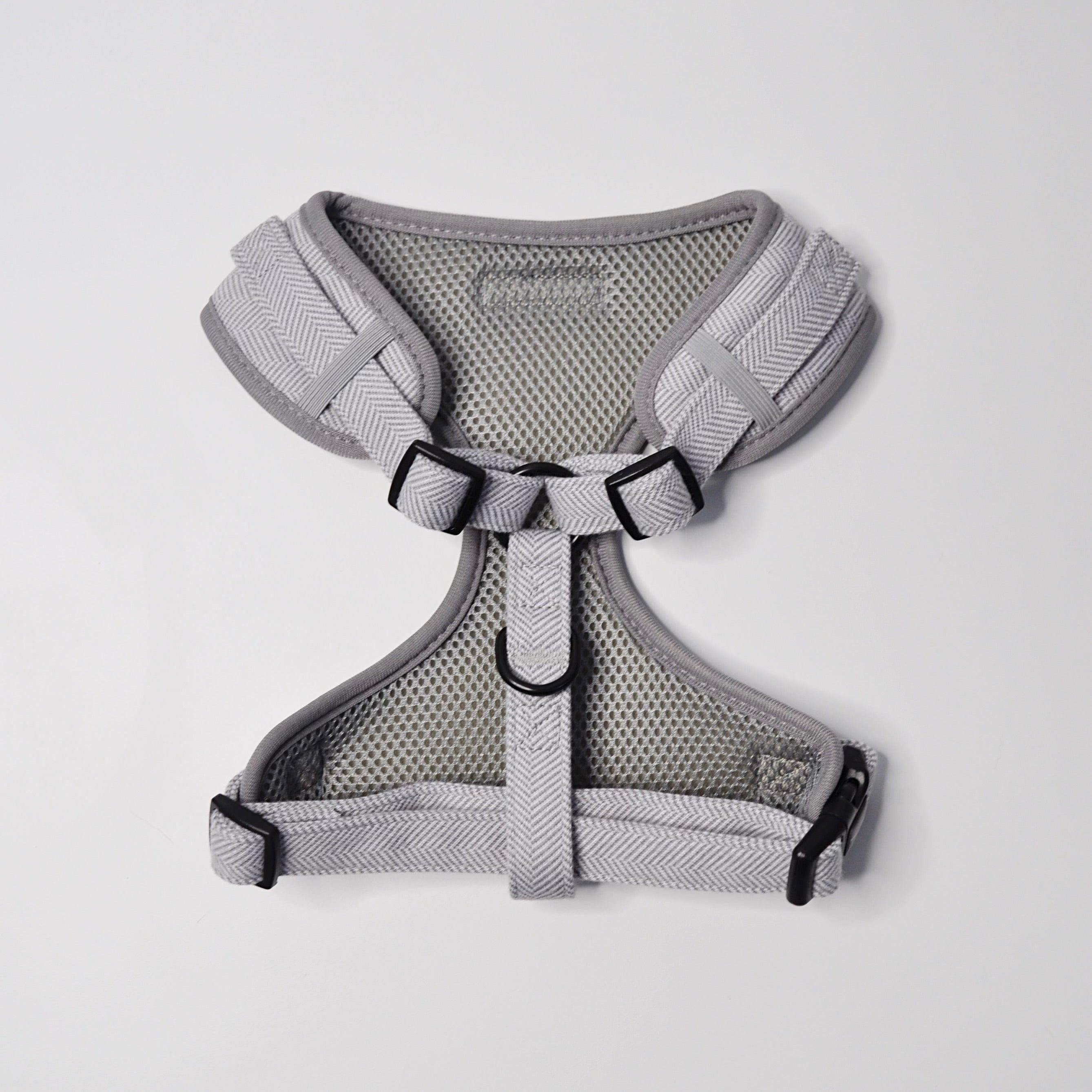 Close-up of adjustable strap and secure buckle on grey tweed dog harness